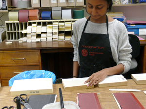 Overcasting a new cloth joint on a circulating book.
